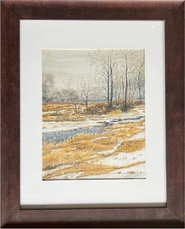 Framed painting of a winter field and bare trees