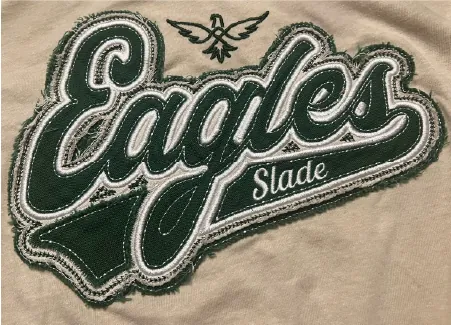 Slade Eagles script logo stitched in green on a cream sweatshirt